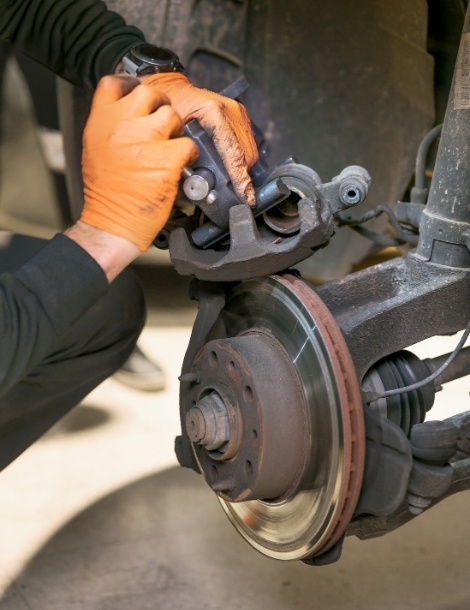 Car mechanic repair brake pads close up