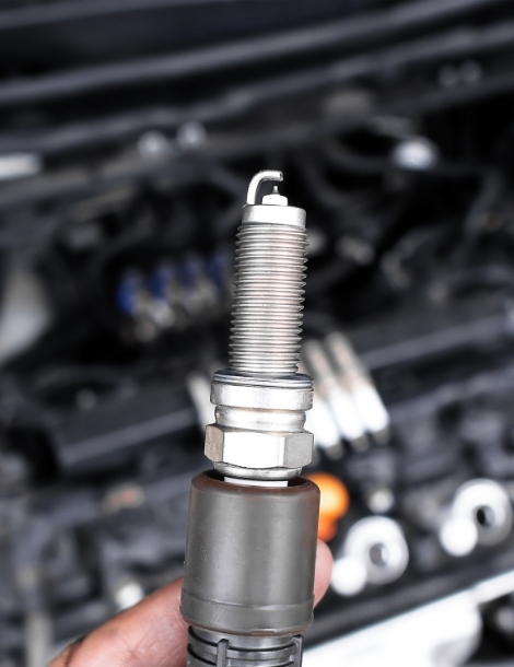 Close-Up of Iridium Spark Plug in Mechanic's Hand